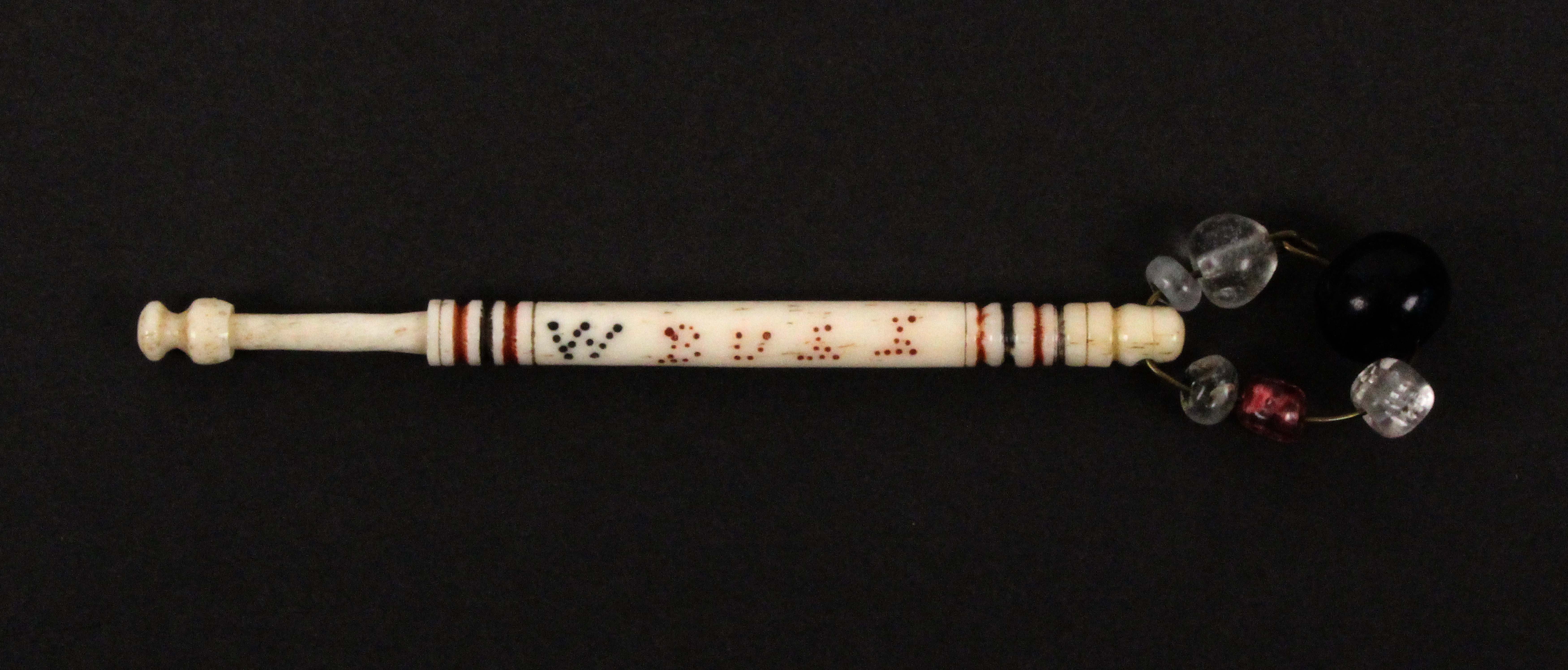 A scarce bone hanging bobbin, spot inscribed in red and black 'W. Bull Hung 1871', attributed to the