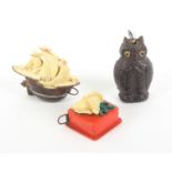 Three novelty celluloid tape measures, comprising a sailing galleon, 5.7cms, a seated owl, 6.5cms,