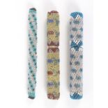 Three beadwork covered cylinder needle cases, comprising a wooden core example covered in