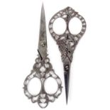 Two pairs of 19th Century Italian steel scissors, comprising a pair with floral scroll arms below