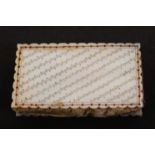 A good mother of pearl pin cushion of rectangular form, one side engraved with diagonal stripes