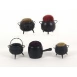 Five Irish bog oak pin cushions, four in the form of cauldrons, three with carved decoration, one