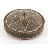 A circular inlaid box, Isfahan, raised on three ball feet the sides in geometric bone, stained