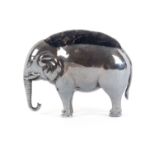 A silver pin cushion in the form of a standing elephant, with purple velvet infill, Birmingham,