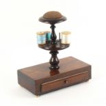 A mid 19th Century rosewood reel stand, the rectangular base fitted with a drawer and raised on four