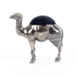 A silver pin cushion in the form of a standing camel, with blue velvet infill, Birmingham, 1906 by