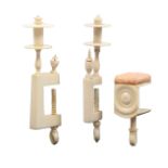 Three 19th Century ivory clamps, comprising two rectangular frame examples below reel tops, and a