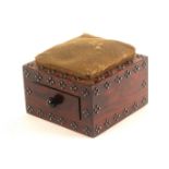 A rosewood weighted pin cushion, of square form decorated with faceted steel pins and fitted to