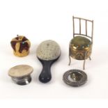 Five pin cushions, comprising a brass example in the form of a chair, 9cms, a gilt brass crown