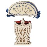 Two 19th Century cut bone pin cushions, one in the form of an open fan with blue silk infill,