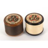 Two J and P Coats one mile wooden reels with labels, one ebonised, 10cms dia., 9cms high. (2) From