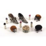 Pin cushions and pin retainers, comprising three 20th Century white metal pin cushions, a frog, a