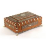 An Anglo-Indian ivory decorated sandal wood sewing box, circa 1830, of sarcophagal form raised on