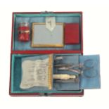 A small continental sewing box of rectangular form covered in patterned red leather, the lid