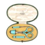 A leather cased four piece silver and pale green guilloche enamel sewing set, Asprey, green