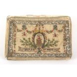 An elaborate 18th Century French embroidered wallet or purse, the outer covers with garlands of