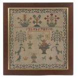 An early 19th Century sampler, in green, red and gold, worked with numerals, trees, birds, flowering