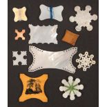 Eleven various thread winders, comprising a Chinese mother of pearl carved snowflake with figures,