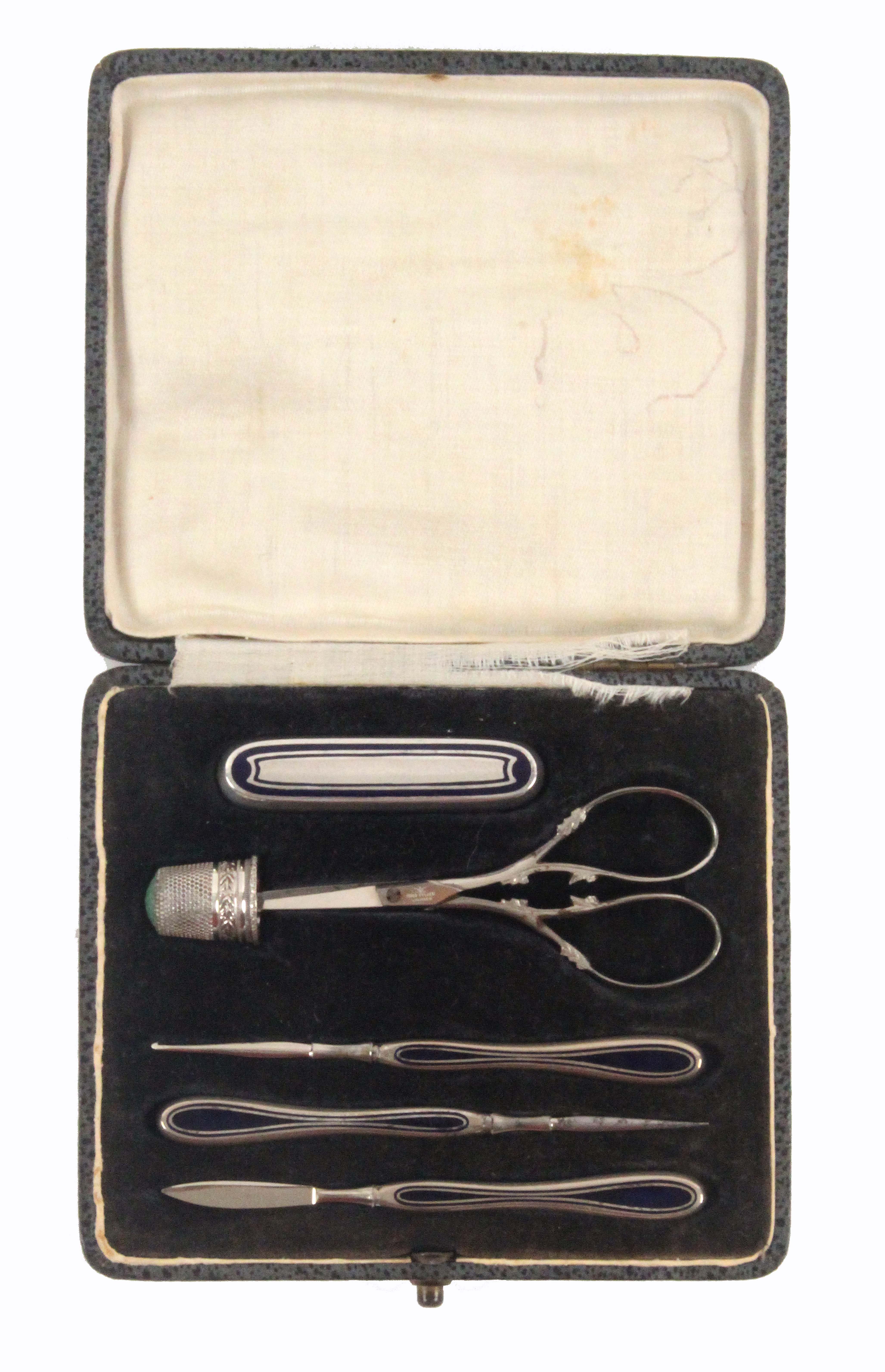 A six piece German white metal sewing set, contained in a leatherette rectangular case, the flush