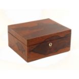 A mid 19th Century rosewood well fitted sewing box, of plain rectangular form veneered in boldly