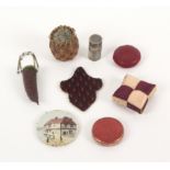 Eight pin cushions, comprising a gilt and silver foil cylinder pin poppet, 3.7cms, a basket form