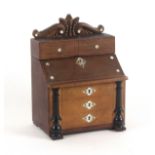 An unusual leather and pearl mounted musical sewing box in the form of a bureau, French or German,