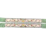 A pair of French early 19th Century ribbon mounted embroidered silk sashes or waist ties, each