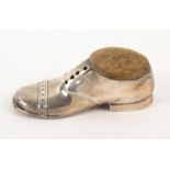 A large silver pin cushion in the form of a brogue shoe, hinged pin cushion to oval box, oak sole,