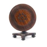 A rosewood pin cushion in the form of a miniature circular top table, the top set at right angles to