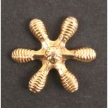 A mid 19th Century gold six point thread winder, probably Dutch, 2.7cms dia.
