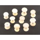 Ten mother of pearl top reel holders, with brass or bone stems to bone bases, including a pair,