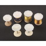 A set of six mother of pearl flower top reel holders, with brass stems and bone bases, one with