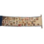 A Victorian strip sampler, mounted on an acorn ended oak pole, the canvas edged in blue silk and