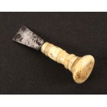 An early 19th Century steel bladed button hole cutter, of wedge form on turned bone handle with