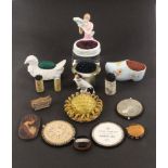 Four ceramic pin cushions and other pieces, comprising a German porcelain example of a young woman