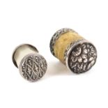 Two button end silver waxers of cylinder form, one with floral decorated domed ends, 2.7cms, the