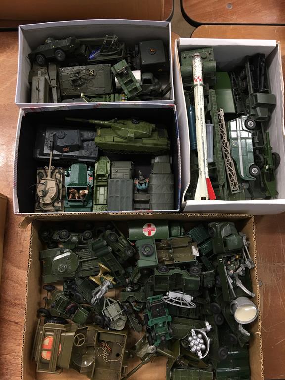 Quantity of loose Die Cast military vehicles etc., in four boxes