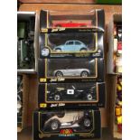 Five boxed Die Cast cars Maisto, Burago and Road Tough