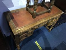 A small oak writing desk, with inset leather top and five drawers, 106cm wide