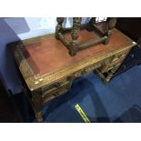 A small oak writing desk, with inset leather top and five drawers, 106cm wide