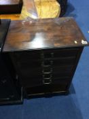 An Edwardian walnut five drawer music cabinet