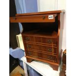 A Yew wood bedside chest, with brushing slide