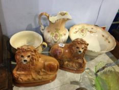 A pair of Victorian Staffordshire lions with glass eyes and a three piece wash set