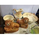 A pair of Victorian Staffordshire lions with glass eyes and a three piece wash set