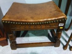 An oak leather top stool