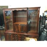 A reproduction mahogany break front bookcase and a corner cabinet