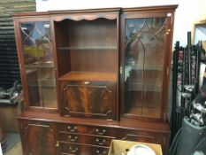 A reproduction mahogany break front bookcase and a corner cabinet