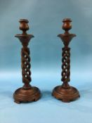 A pair of wood barley twist candlesticks