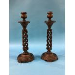 A pair of wood barley twist candlesticks