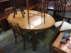 A G Plan teak table, four chairs and cabinet